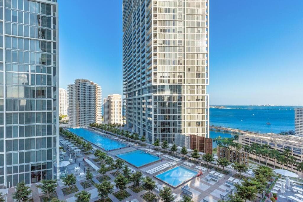 Expansive high-rise views overlooking the luxury pool deck and ocean.