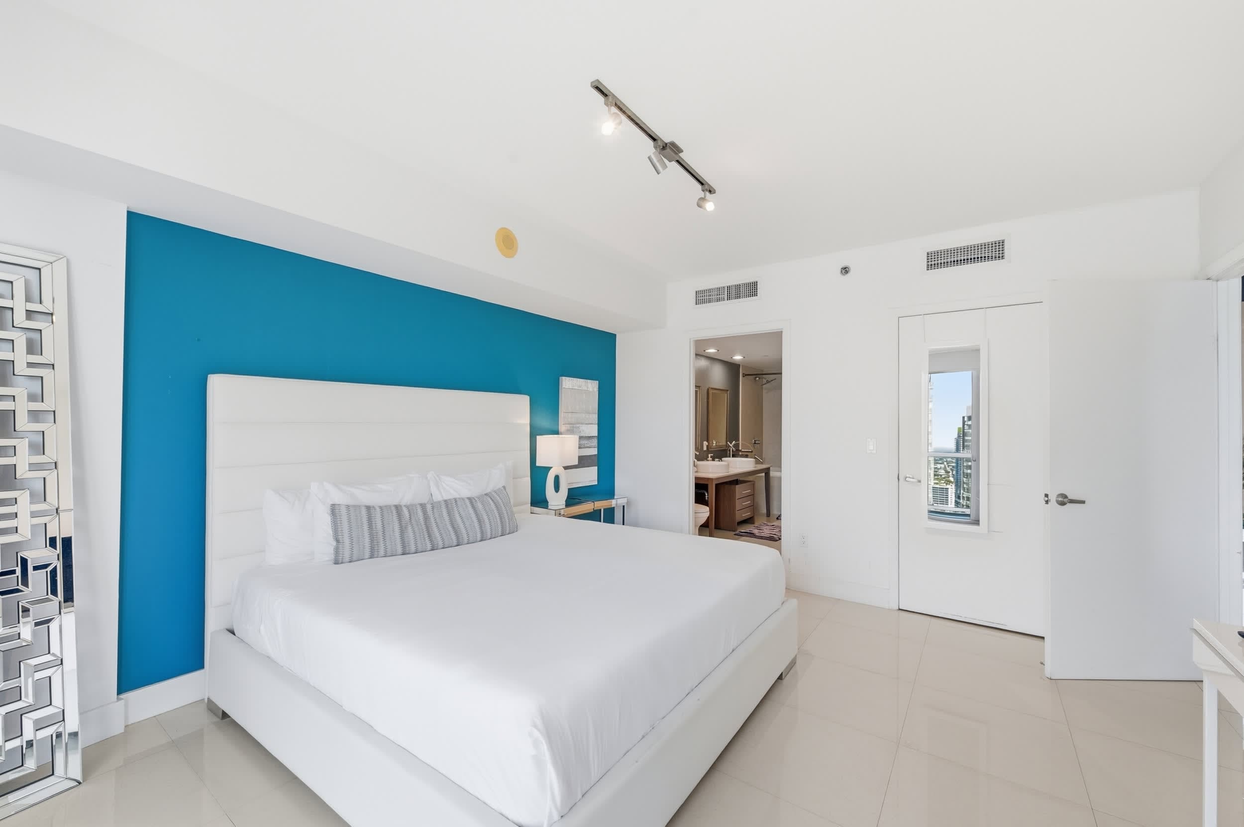 Serene master bedroom with a plush bed.