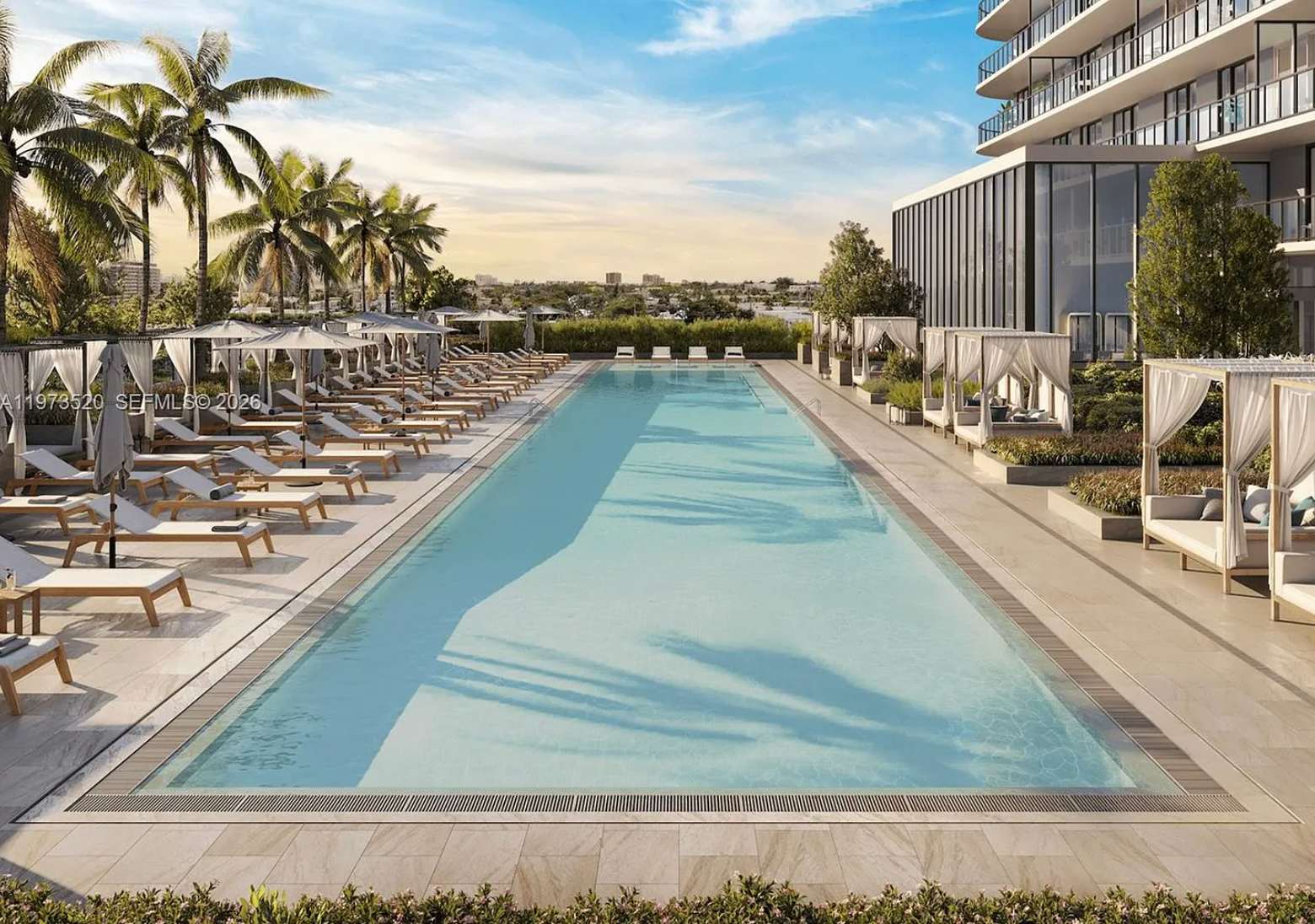 The resort-style pool framed by tropical palms at 72 Park, Miami Beach
