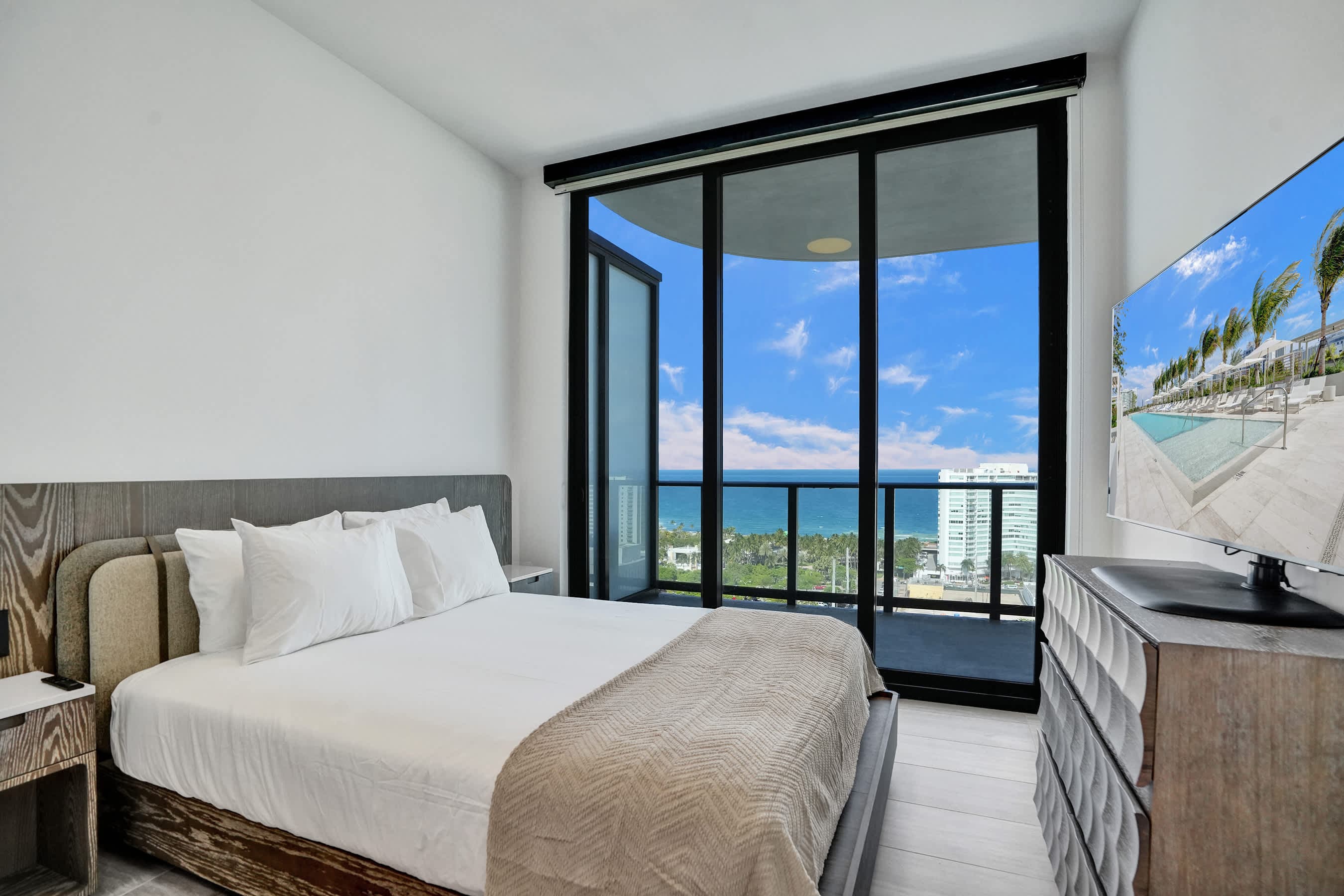 Sun-drenched master bedroom with private balcony access