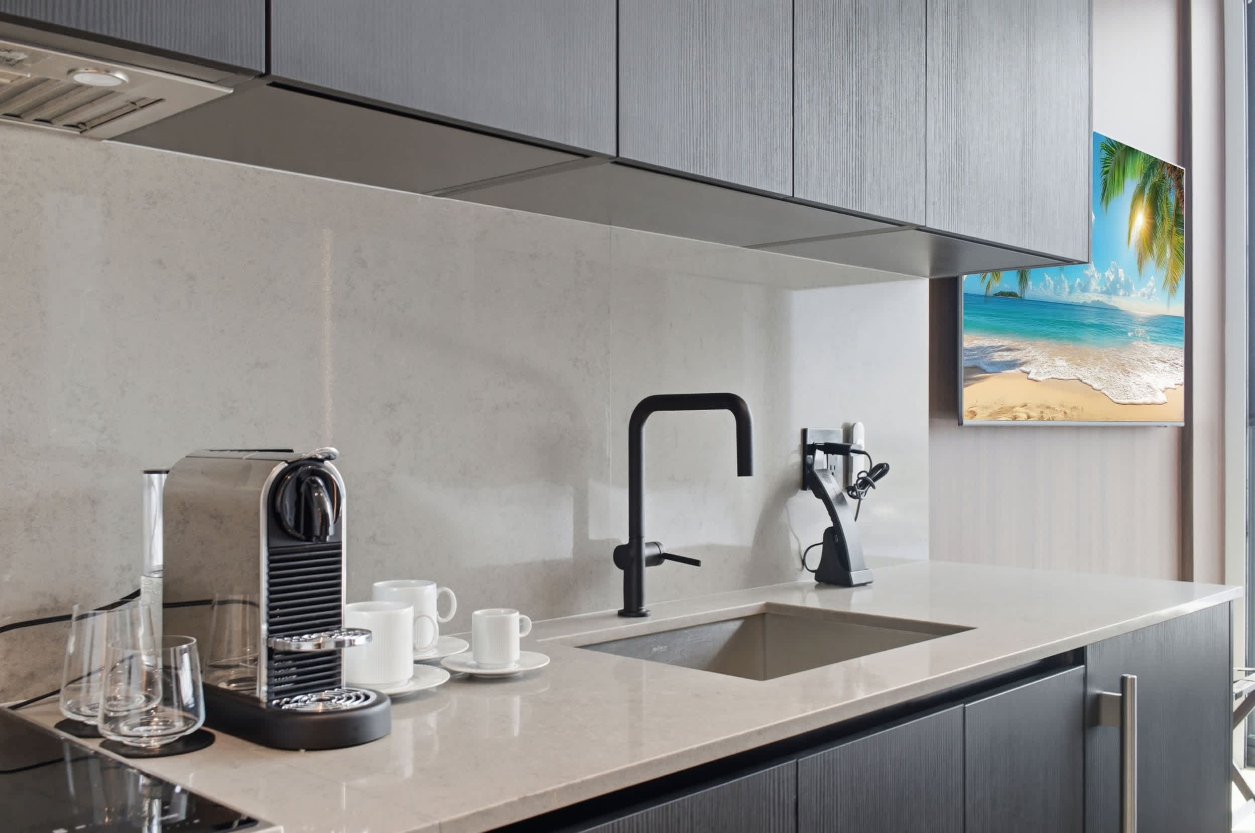 Kitchen sink beside a coffee station.