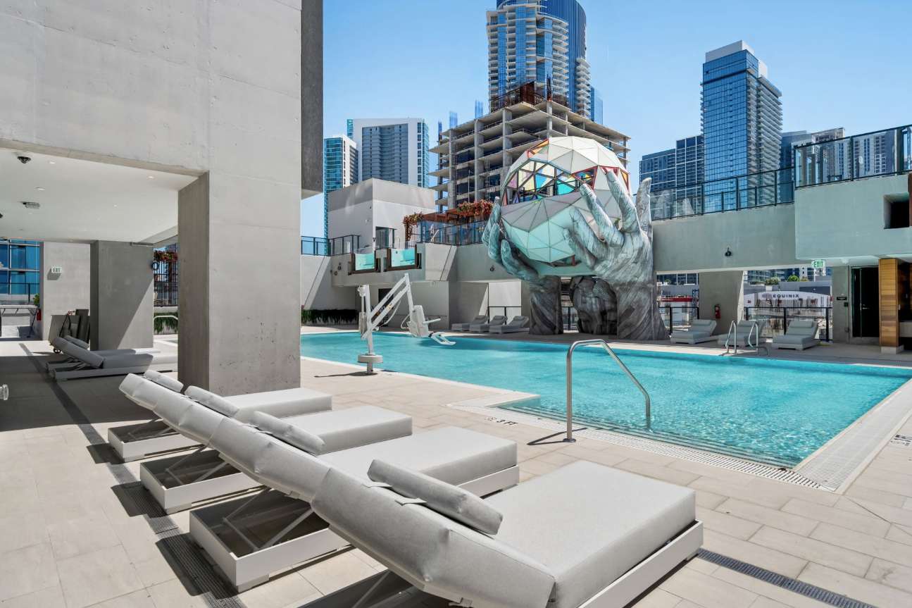 The resort-style pool deck and loungers at The E11EVEN Residences, Downtown Miami