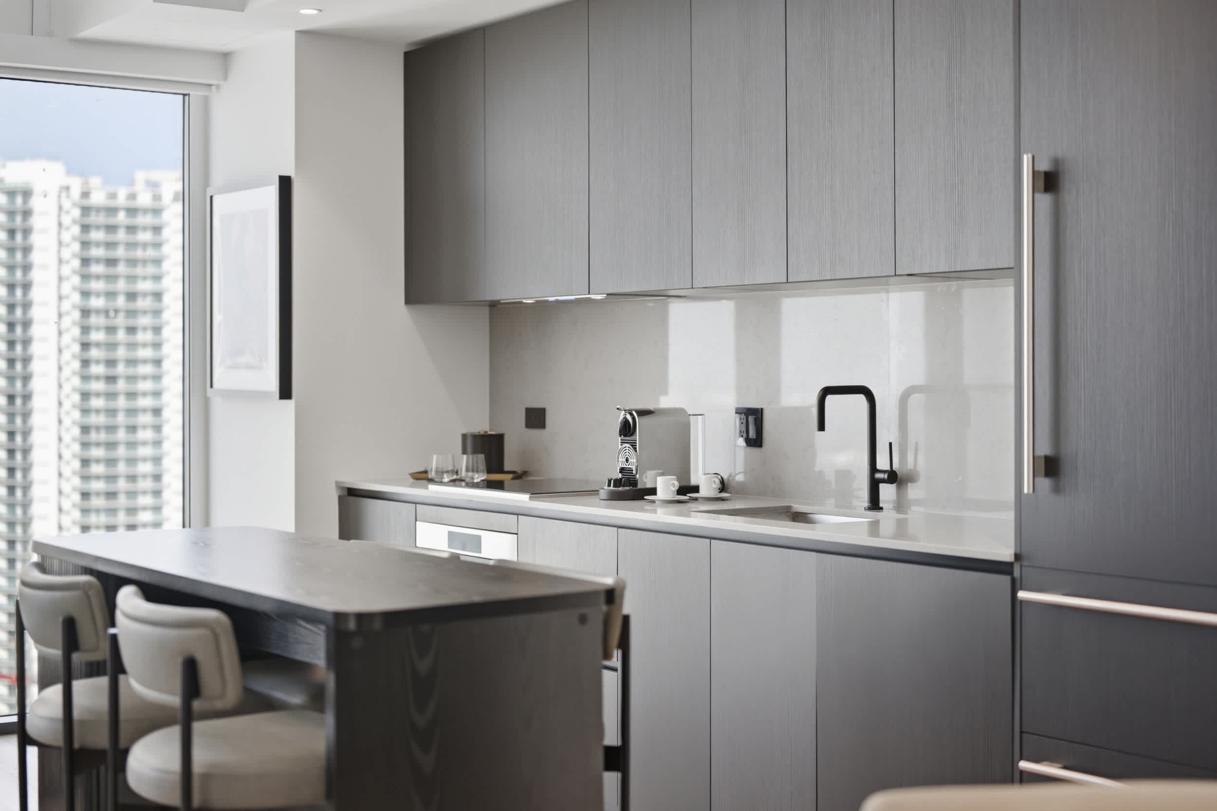 Sleek kitchen with contemporary grey cabinetry.