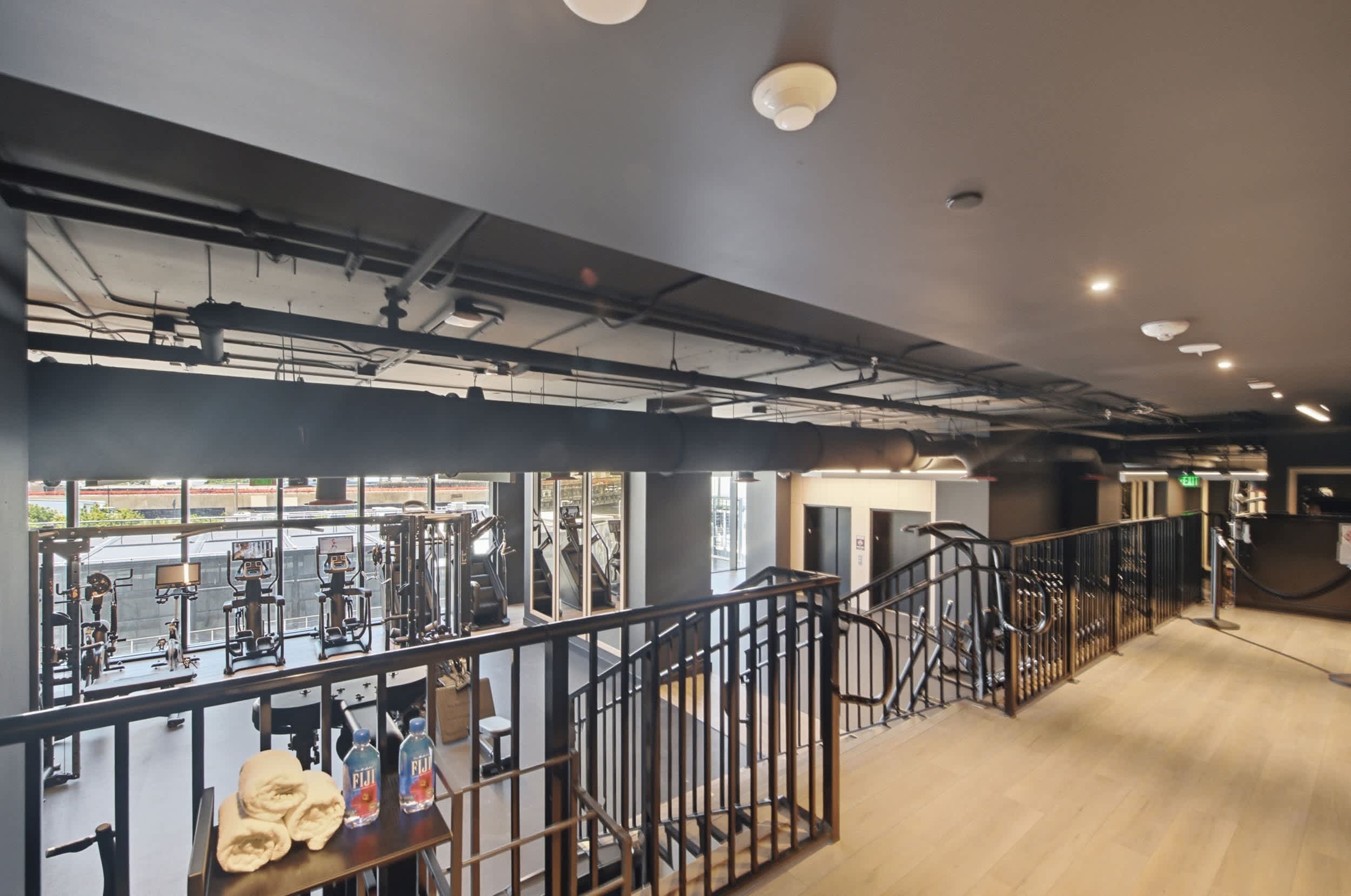 Upper-level walkway overlooking the fitness area.