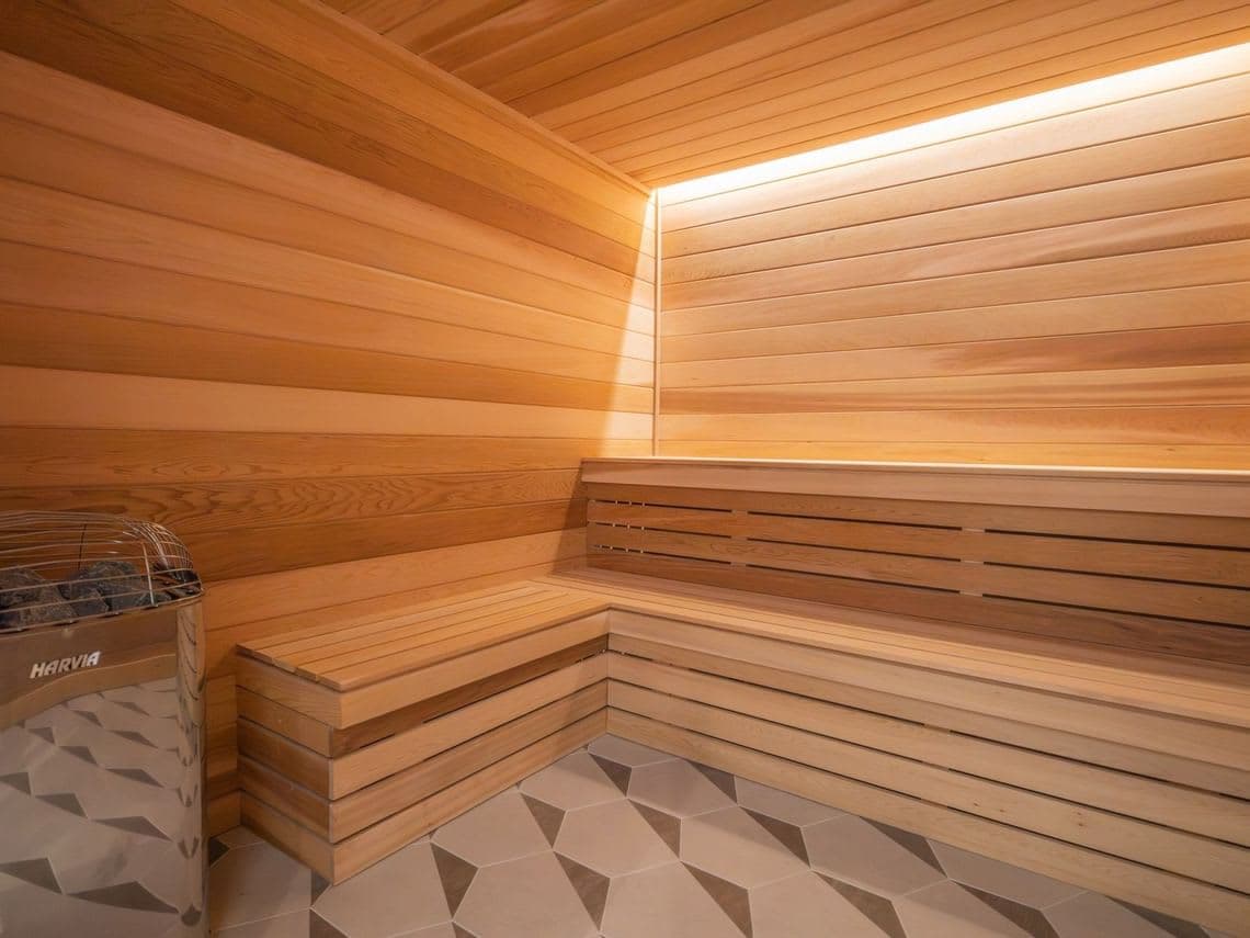 Wood-paneled sauna with tiered benches.