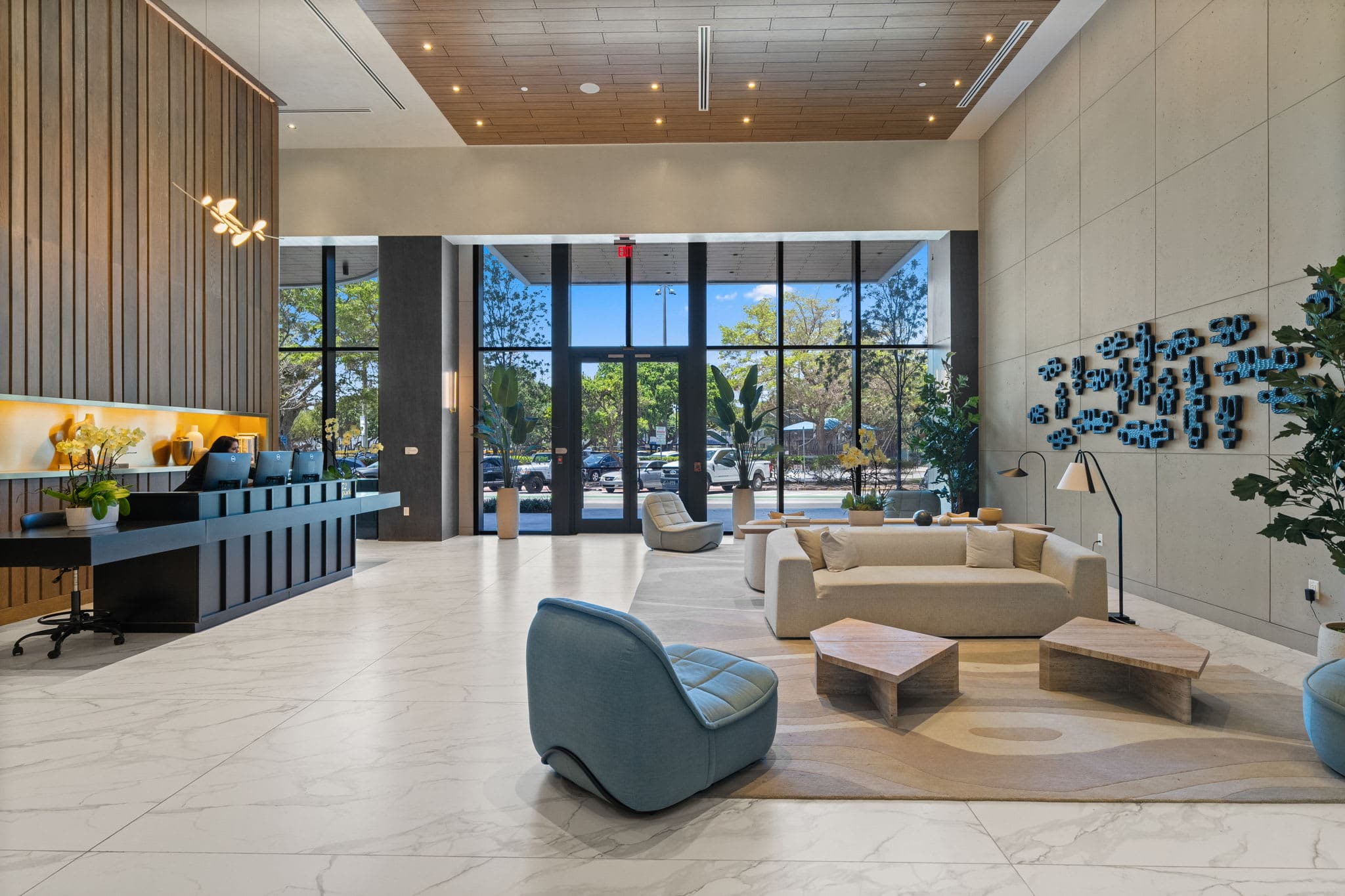 Lobby with a reception desk and curved seating.