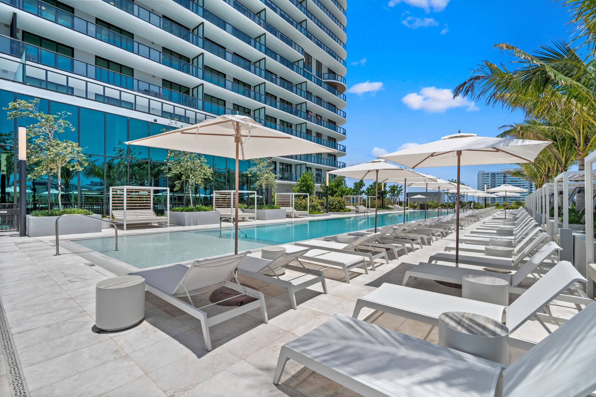 Poolside loungers and cabanas beside the tower.