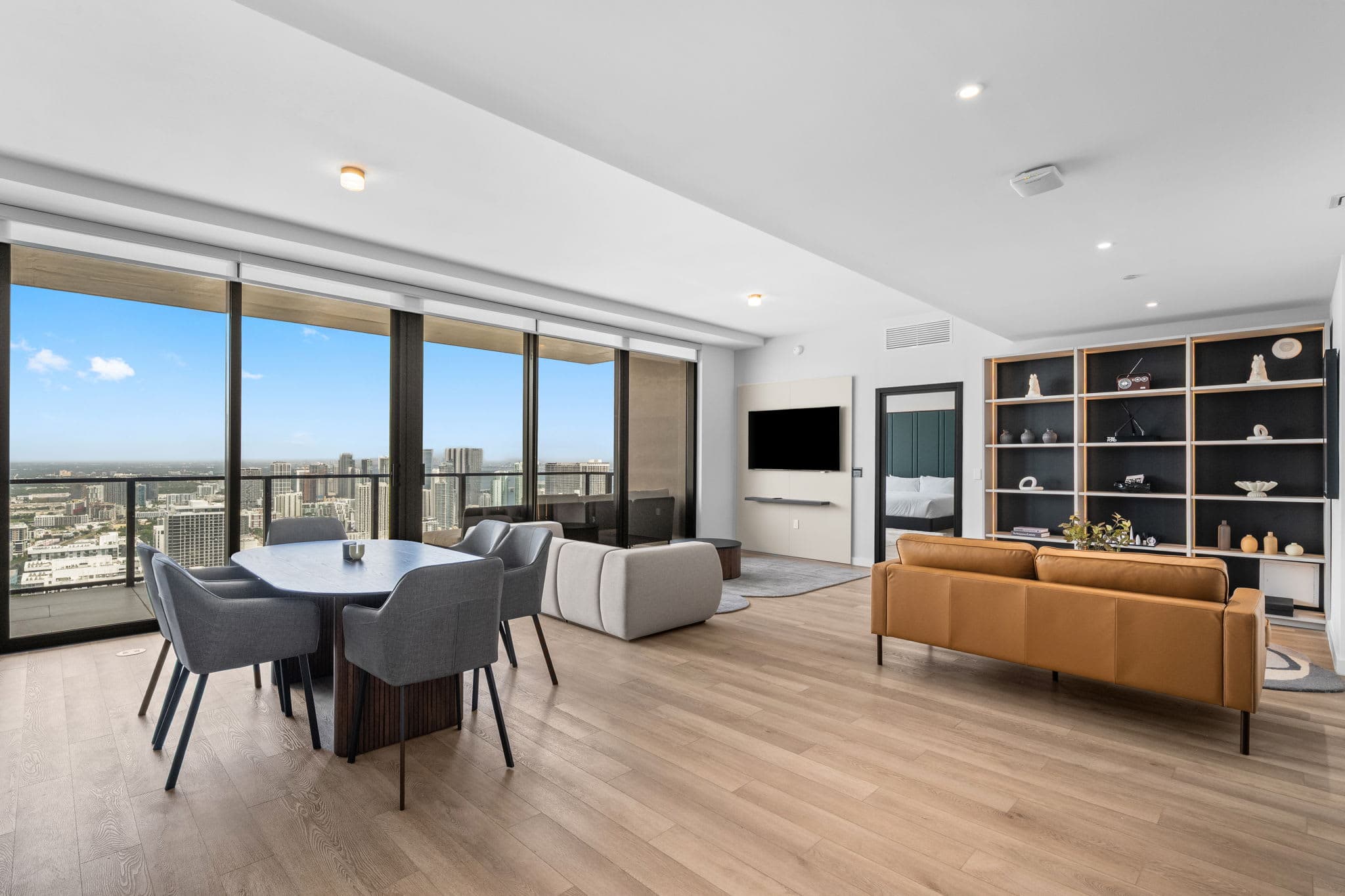Spacious bedroom with floor-to-ceiling city views.