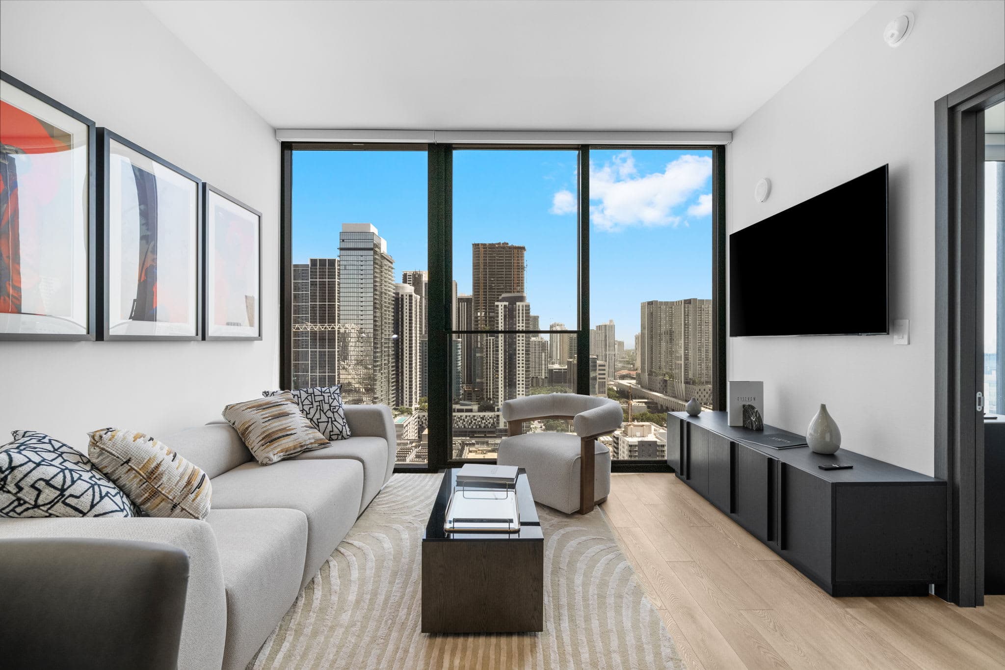 Living room with a sofa and city-view windows.